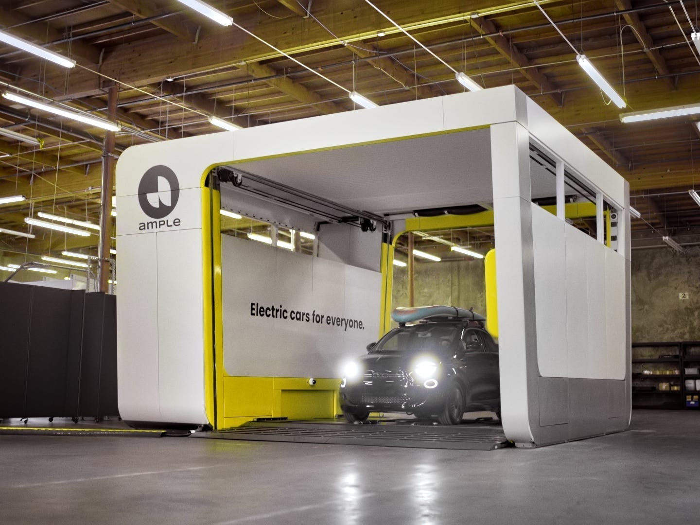 A driver leaves the battery swapping station with a new, fully charged EV battery.