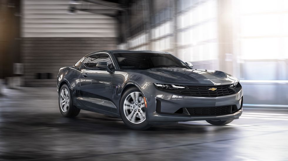 passenger front 34 view of chevrolet camaro cornering inside a garage