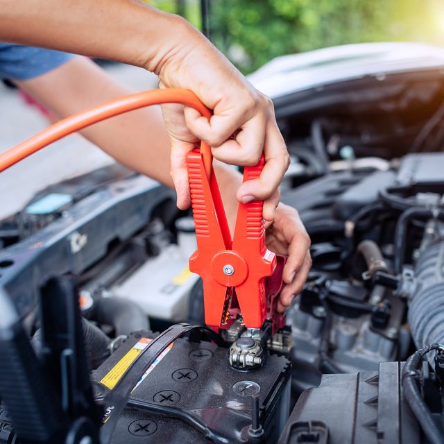 close up of auto mechanic jumping battery car