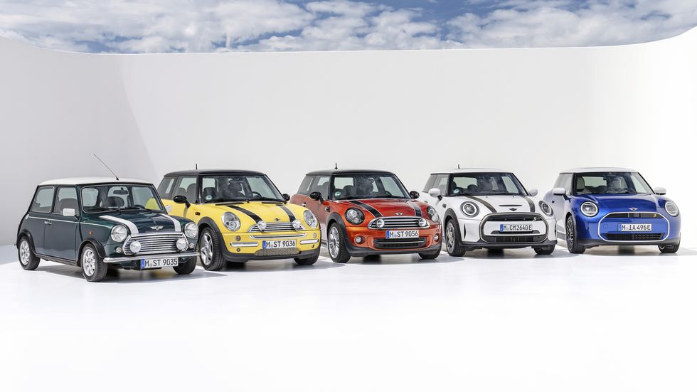 historic mini cooper lineup in a rainbow of colors all lined up in a photo studio