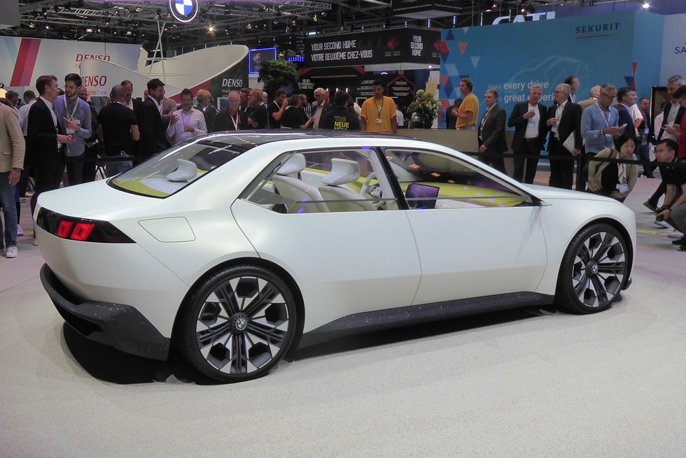 the bmw vision neue klasse concept shown in white from the right side on the floor at the 2023 iaa mobility show