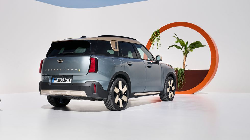 2025 mini cooper countryman electric in light blue with a cream and black interior on photo studio