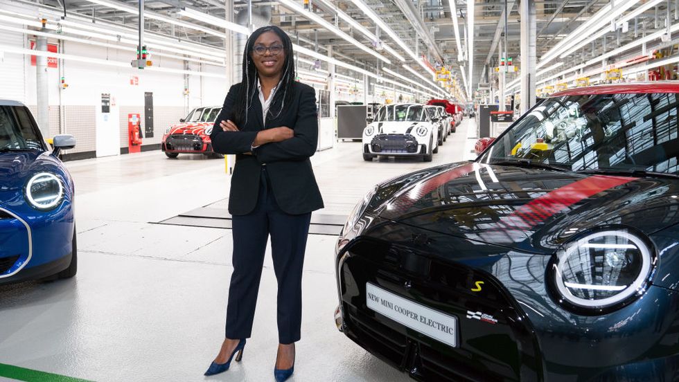 uk ﻿trade secretary kemi badenoch standing next to mini cooper